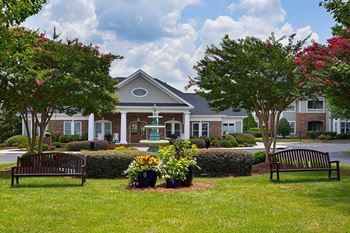A building with a green lawn in front of it.